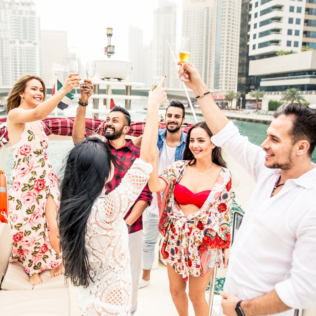 group of people on the deck of a yacht raising a glass